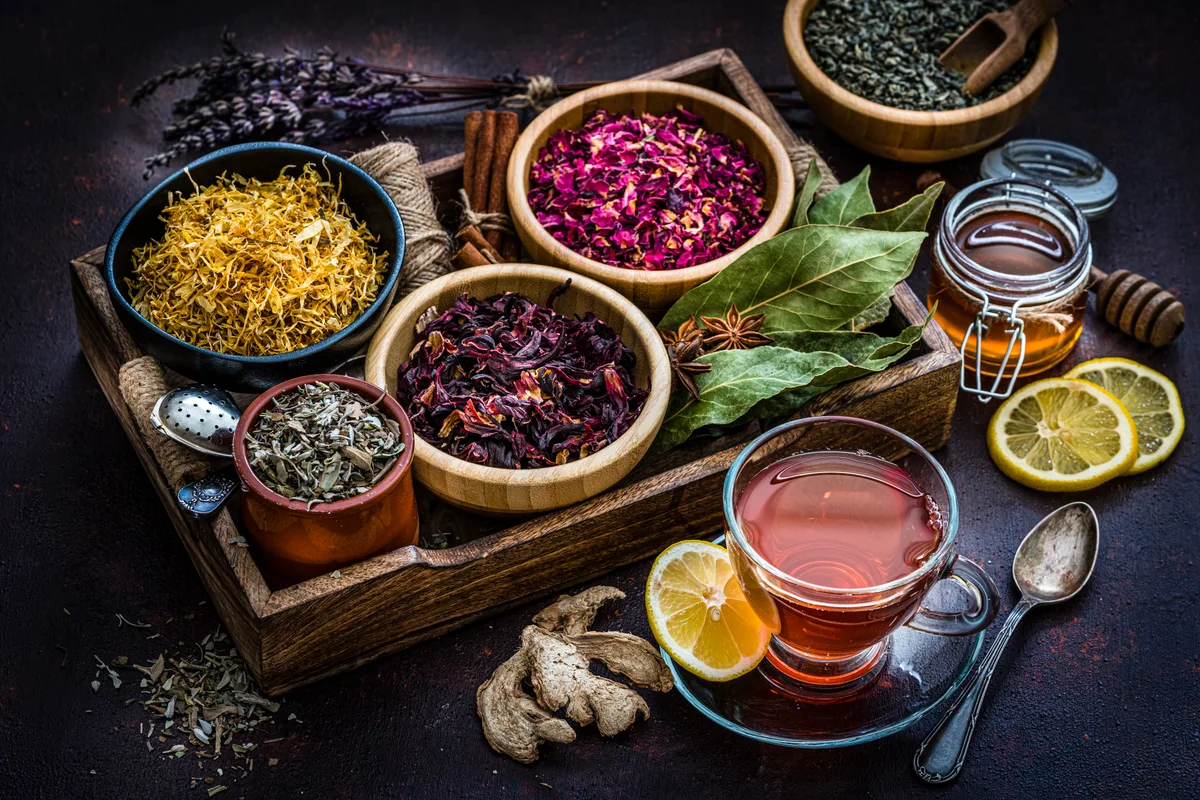 Dried hibiscus flowers and other herbs in open sacks