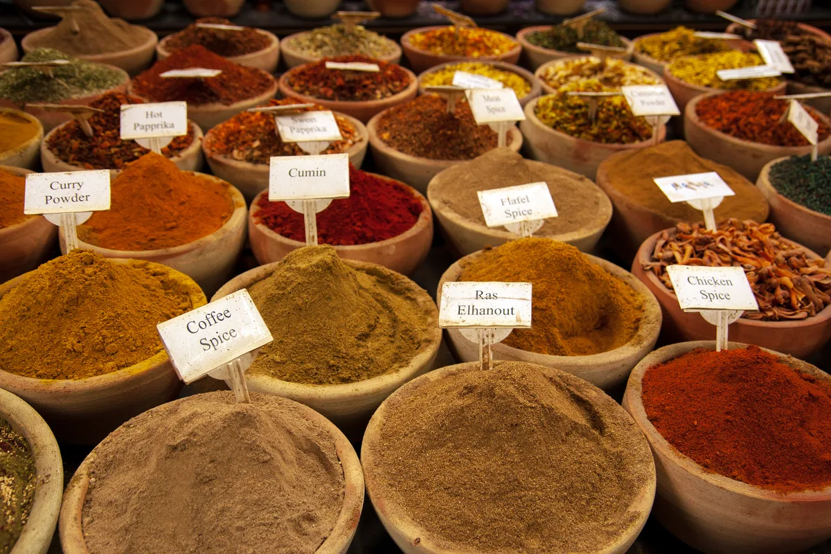 Whole black seed and other whole spices in small bowls